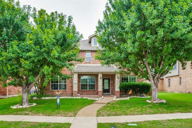 View of front facade with a front lawn at 11186 Round Mountain Drive, Frisco, TX 75035