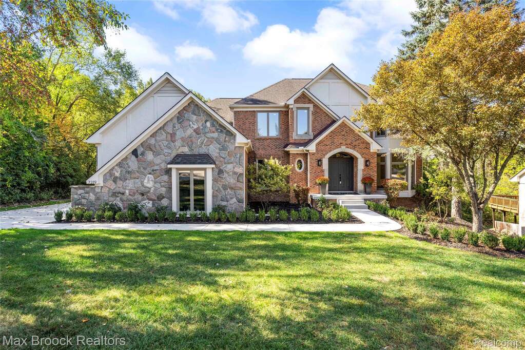 View of front of house with a front lawn and brick siding at 7219 Oakwood Drive, West Bloomfield, MI 48322