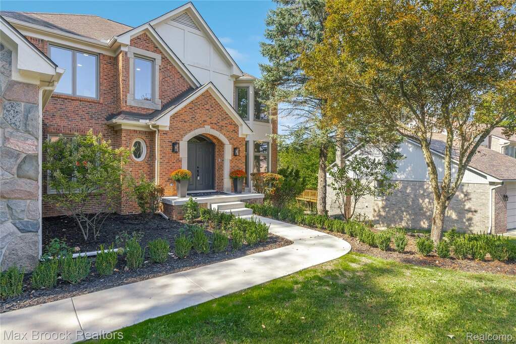 Tudor home featuring a front yard and brick siding at 7219 Oakwood Drive, West Bloomfield, MI 48322