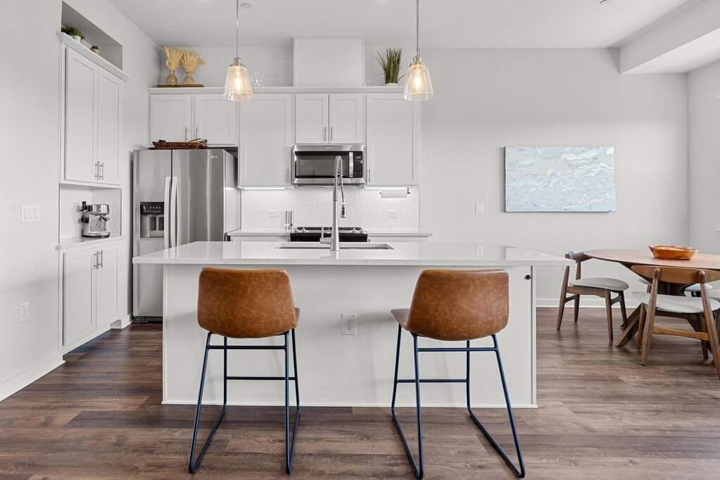 With the tile backsplash adding a pop of detail and the center island with a breakfast counter, the kitchen becomes a place not just for cooking, but for gathering, chatting, and sharing meals with loved ones at 12001 Vista Parke Dr #1102, Austin, TX 78726