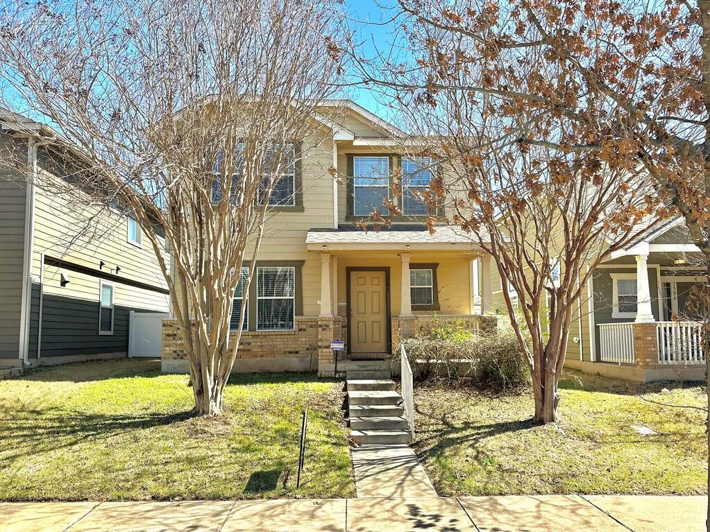 View of front facade featuring covered porch, a front yard, and brick siding at 1506 Big Thicket Dr, Cedar Park, TX 78613
